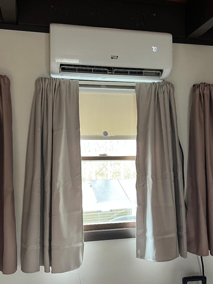 Indoor mini-split head unit above a window