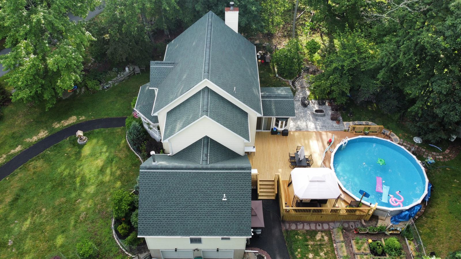 Drone view of a completed slate-green roof replacement on a home in the Pocono Mountains