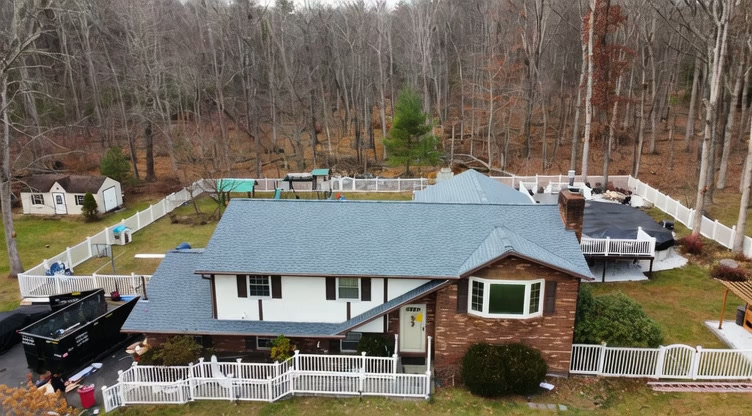 Aerial view of a completed roof replacement by All In One Building